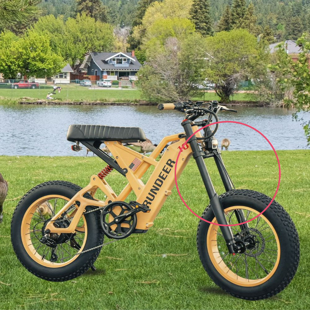 Rundeeer Attack 10 e-bike with front suspension on a grass field