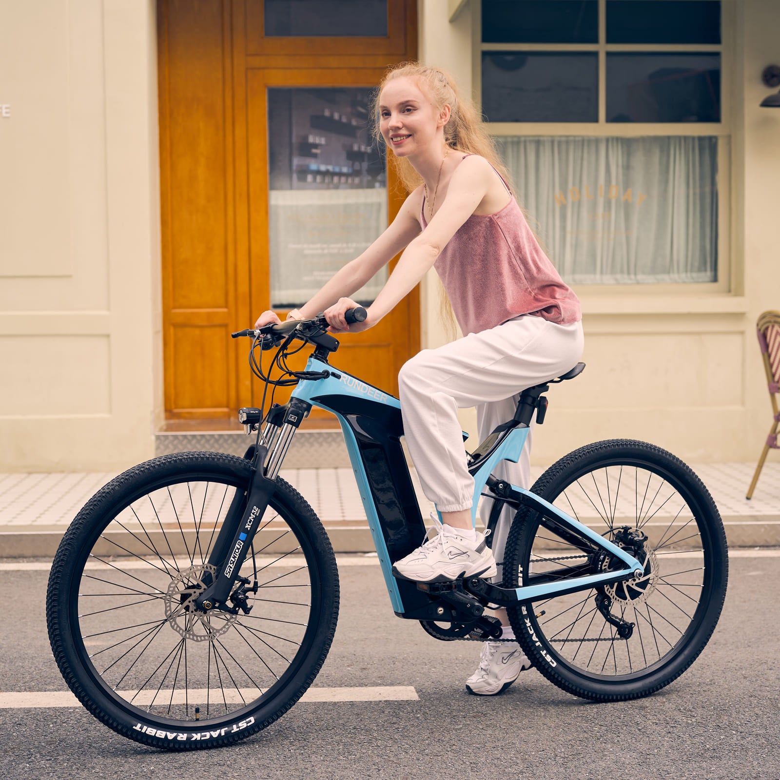 Woman riding Rundeer Starry Sky electric bike on city street